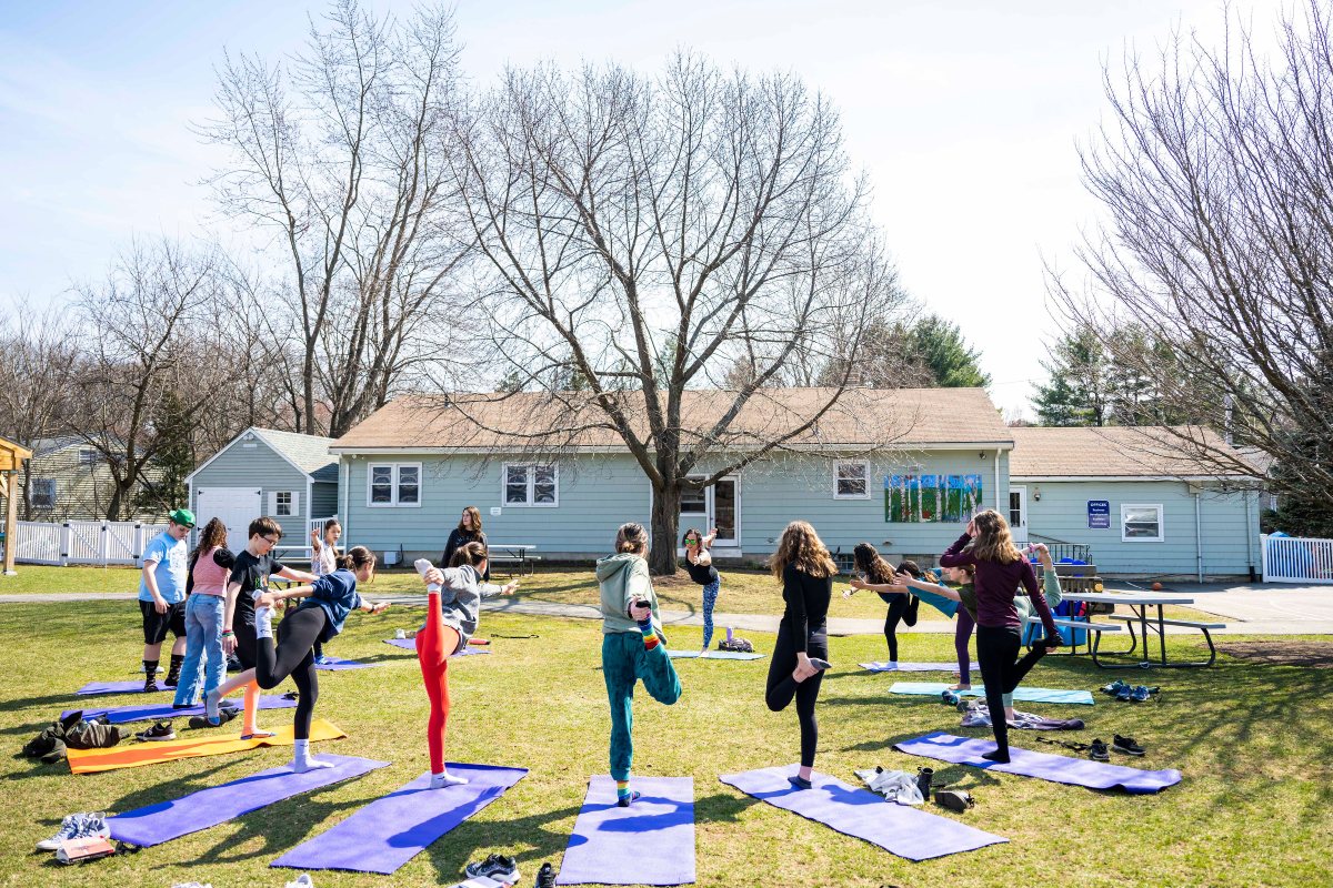 Middle School students doing yoga outdoors
