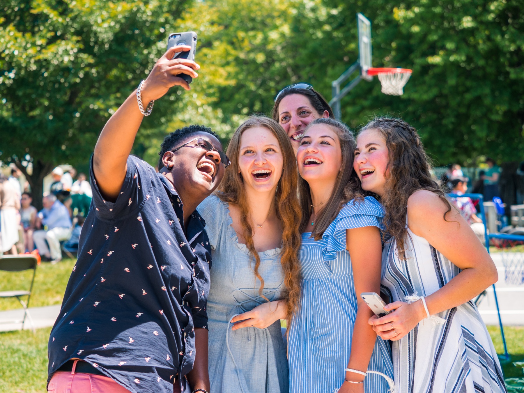 Group of 5 LMS alums laughing while having a selfie