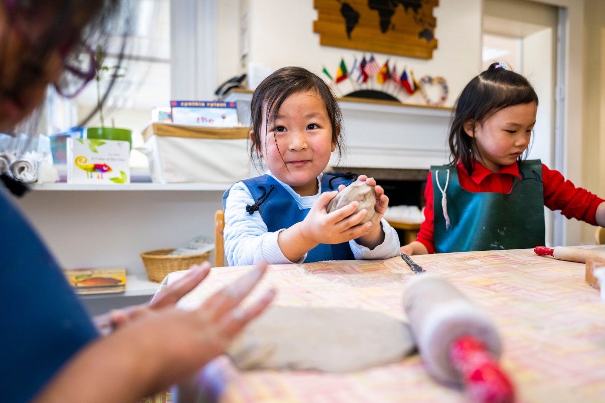 Girl playing with clay, indoors