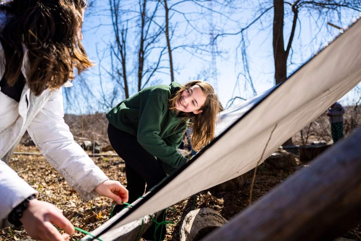Two LMS  middle school students tying a tent